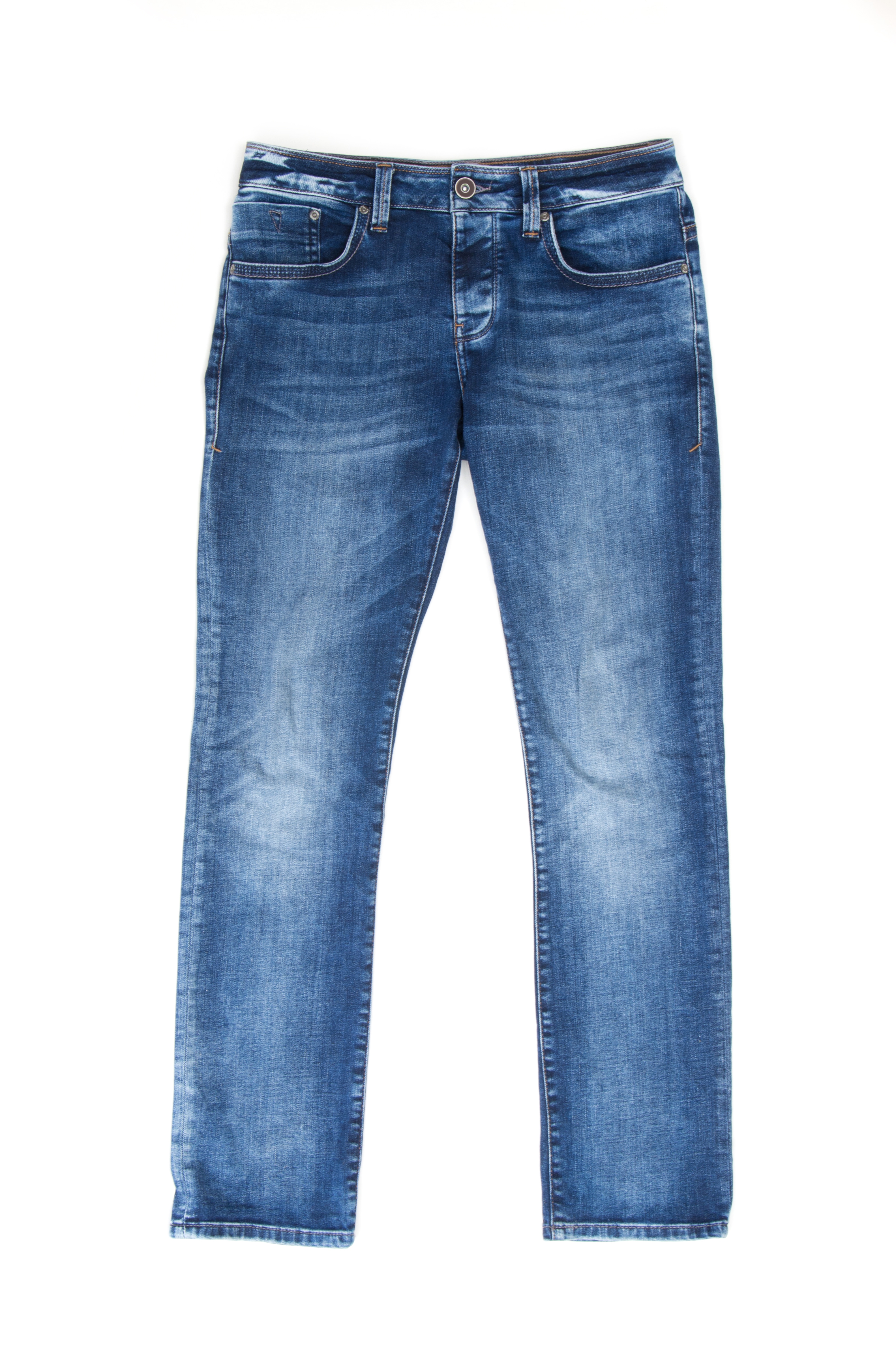 A pair of blue denim jeans laid flat on a white background