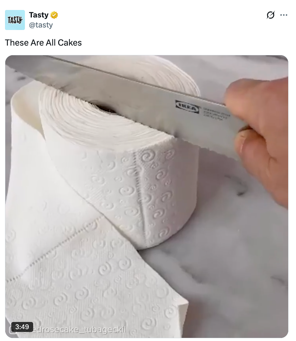 A video shows a realistic toilet paper roll cake being sliced with a large knife, revealing it is made entirely of cake