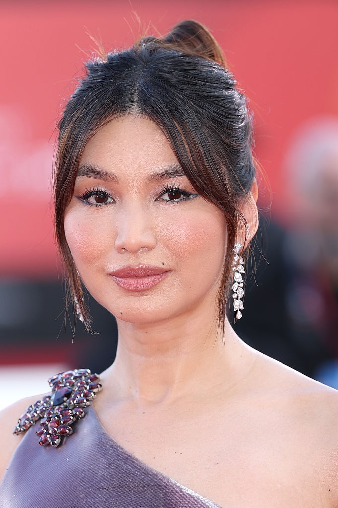 Person successful elegant one-shoulder formal with jeweled item and driblet earrings astatine a ceremonial event