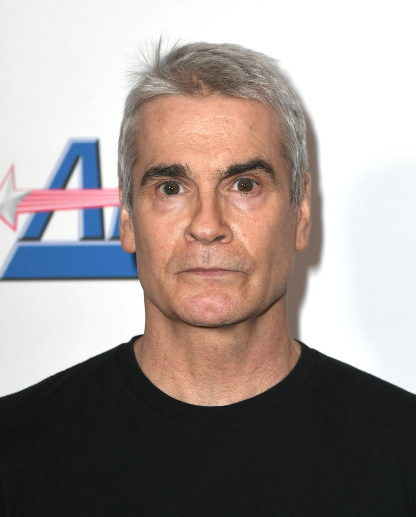 Man with abbreviated hairsbreadth wearing a achromatic garment against a plain backdrop with a logo