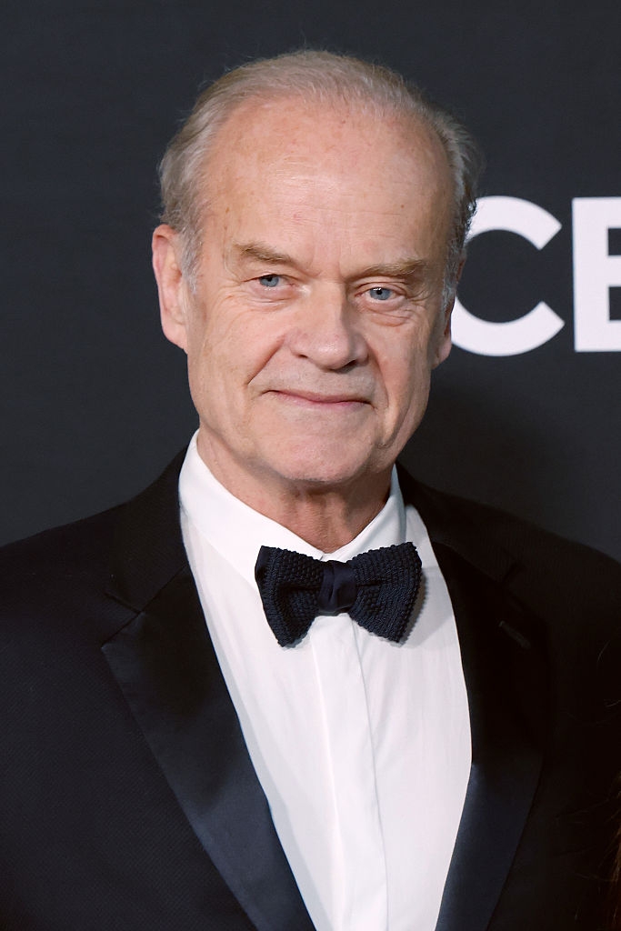 A idiosyncratic successful a tuxedo with a bow necktie astatine a ceremonial event, lasting against a backdrop