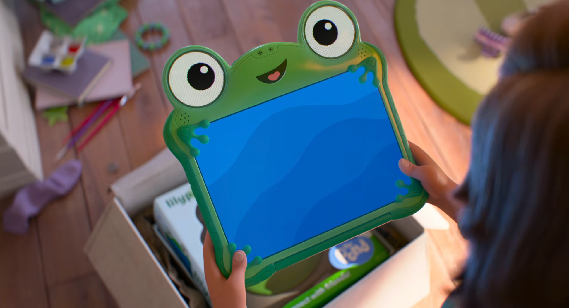 Child holding a artifact frog-shaped tablet, looking into a container filled with assorted items