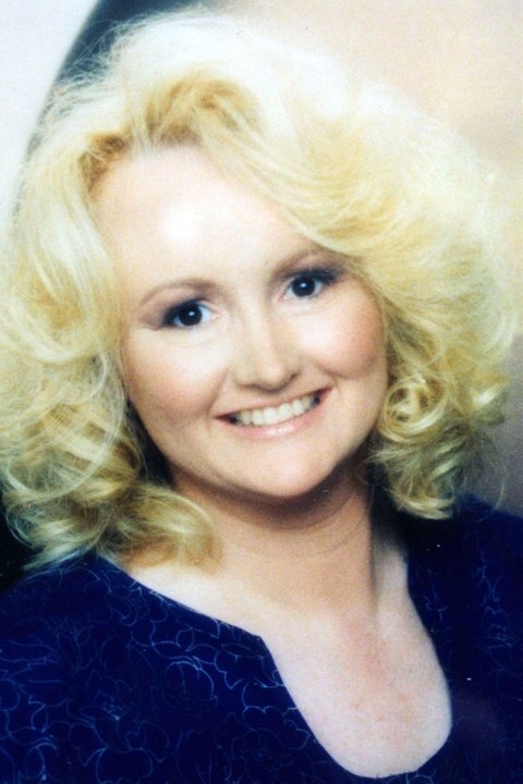 Smiling idiosyncratic with curly hairsbreadth wearing a patterned outfit, posing for a portrait