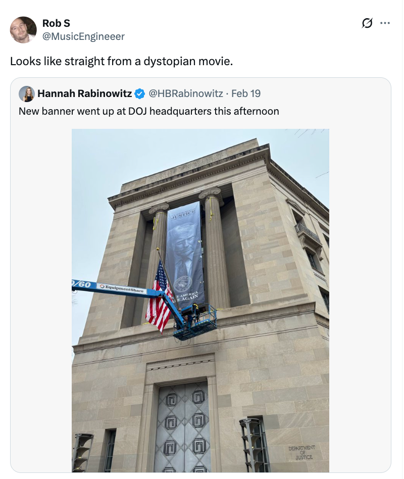 Twitter station  showing a DOJ gathering  with a ample  banner being hung by a crane, resembling a dystopian scene