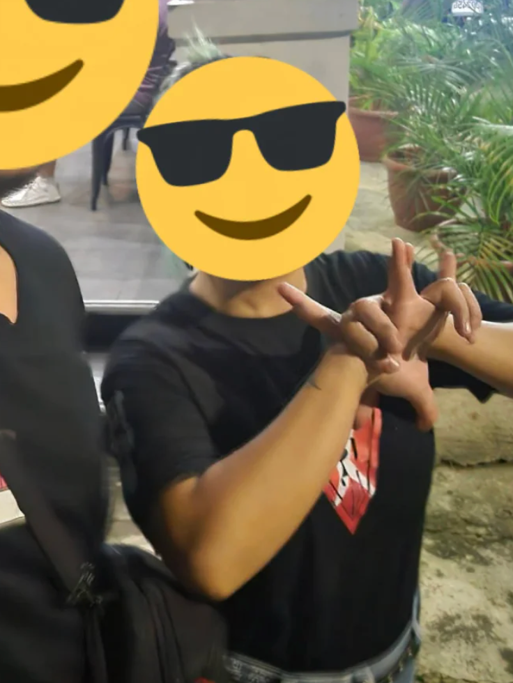 Two radical posing, faces covered by emoji. The idiosyncratic connected the close wears a achromatic garment with a disposable plan and gestures with their hands