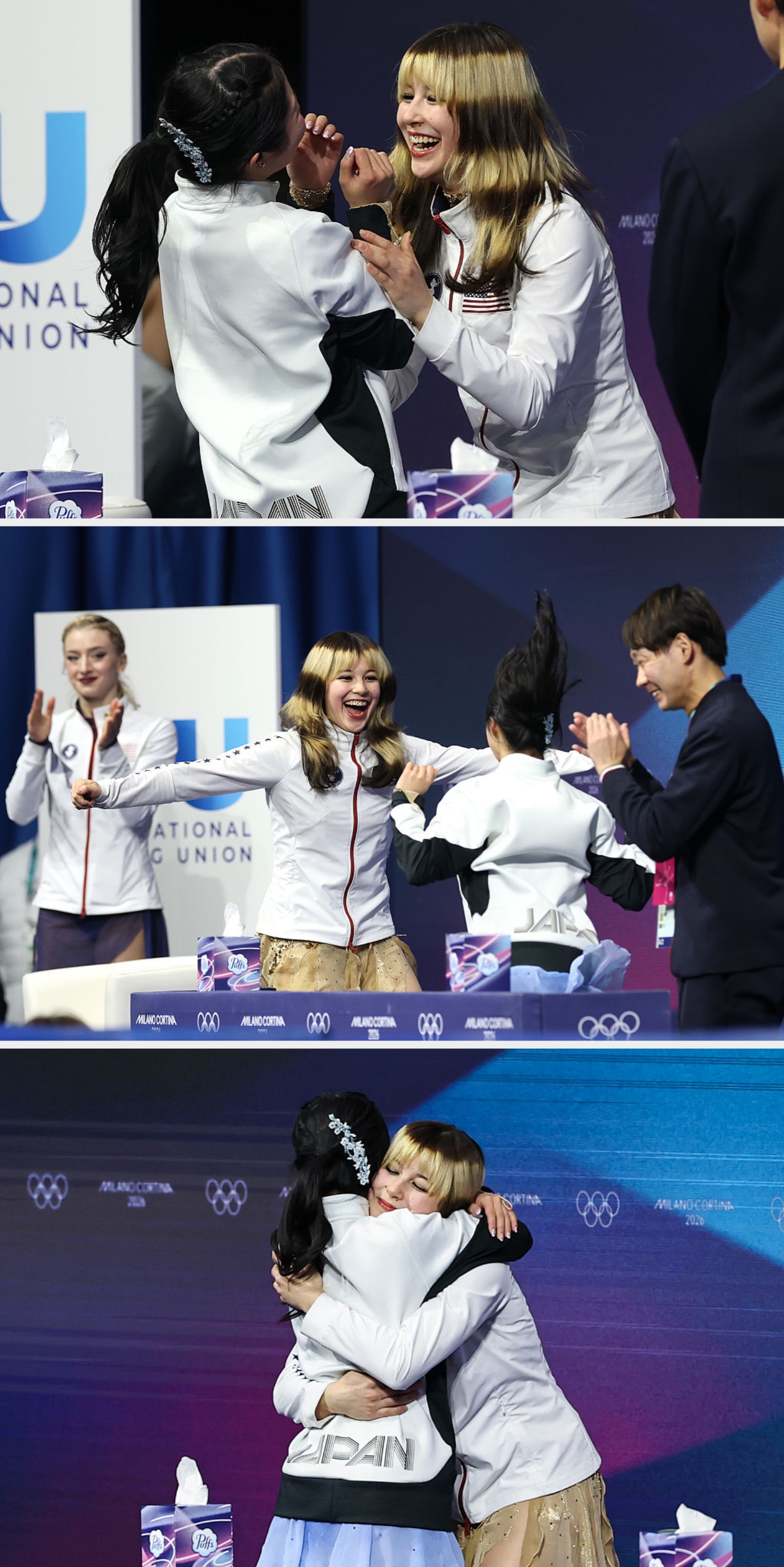 To personer i hvite jakker samhandler med glede på et arrangement, med vev synlig i nærheten