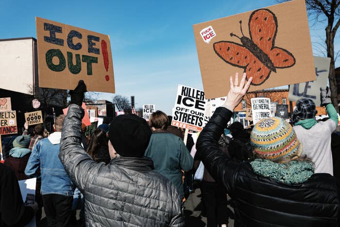 A assemblage  of radical   astatine  a protestation  clasp  signs with messages against ICE, including 1  with a butterfly illustration and different  stating "ICE OUT!"