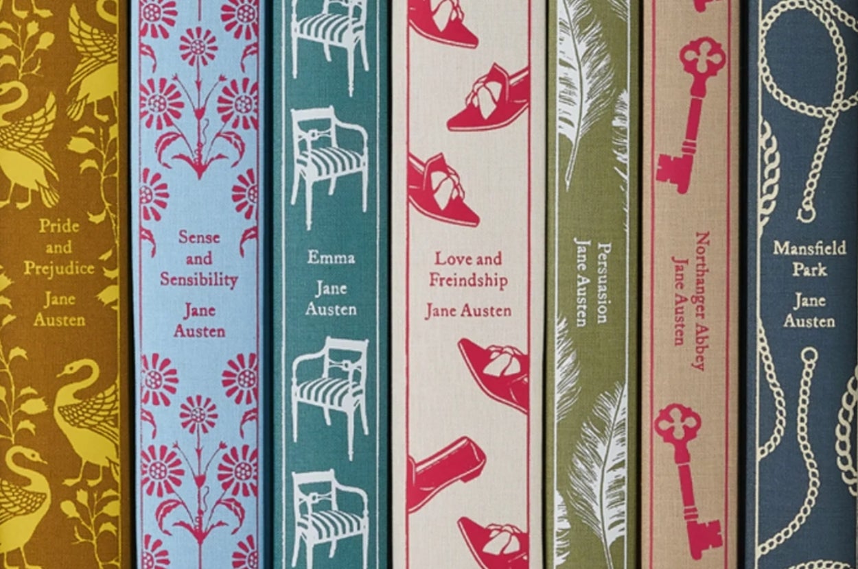 Spines of Jane Austen books with decorative designs: "Pride and Prejudice," "Sense and Sensibility," "Emma," "Love and Friendship," "Persuasion," "Northanger Abbey," "Mansfield Park."