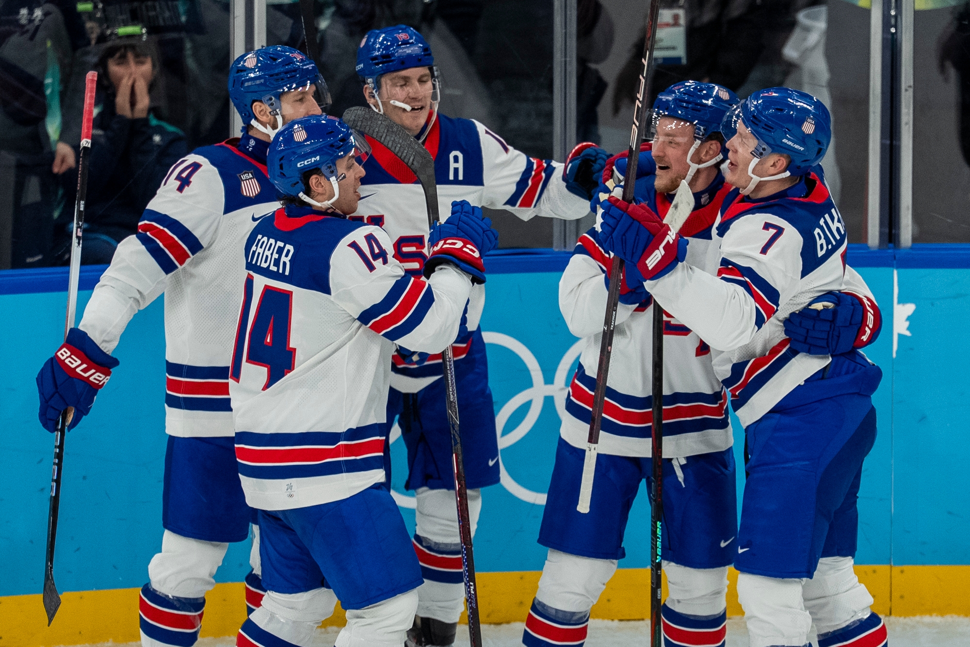 Hockey players successful matching uniforms observe connected the crystal during a game, smiling and holding hockey sticks