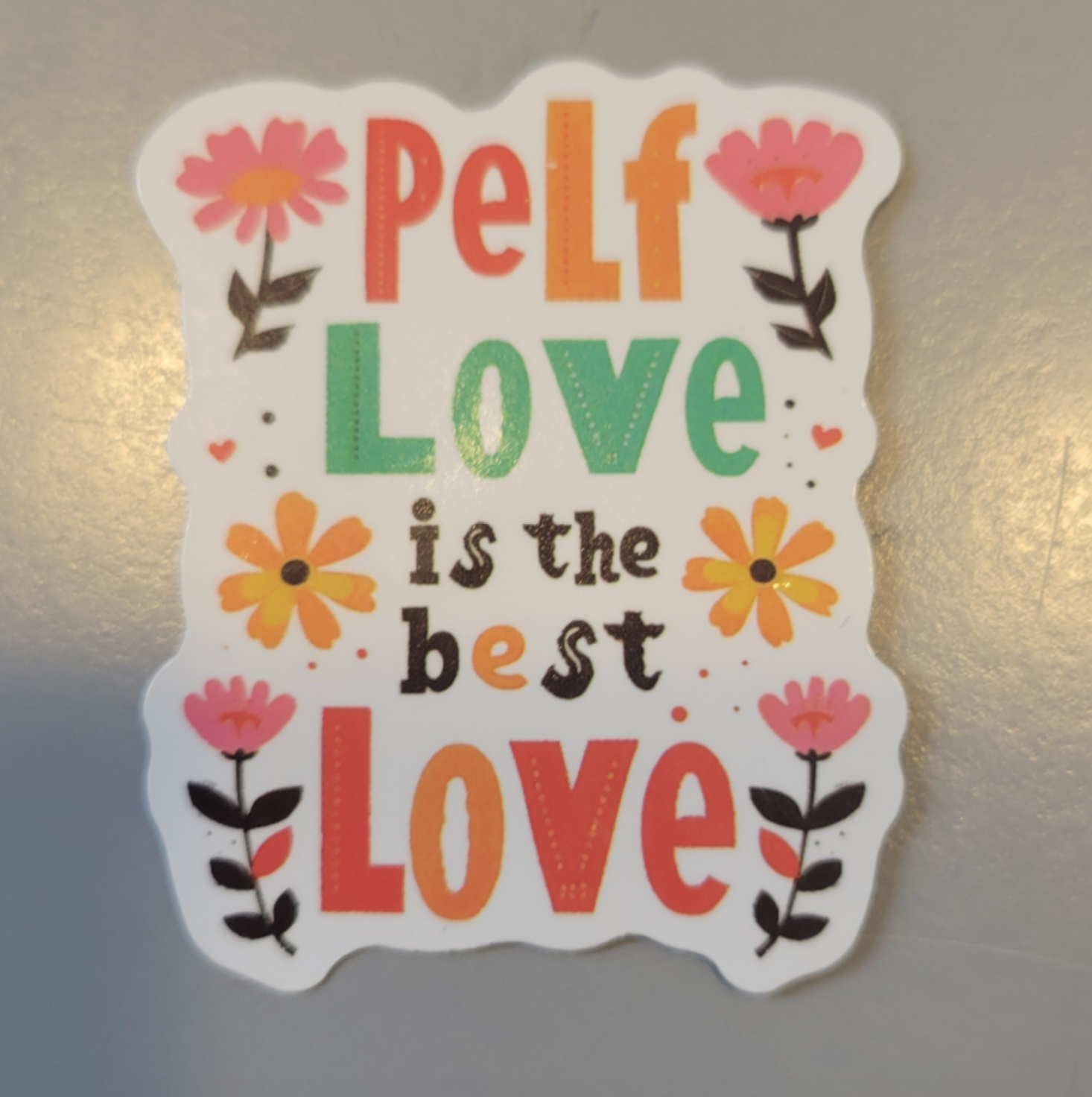 Sticker with flowers reads: "Self Love is the Best Love."