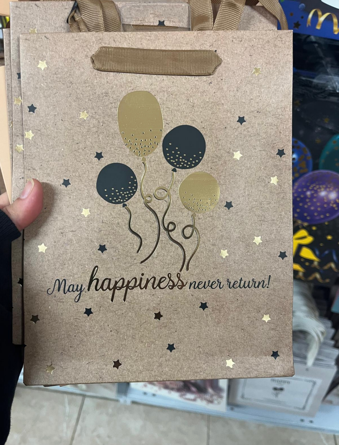 Gift bag with balloons and text: "May happiness never return!"