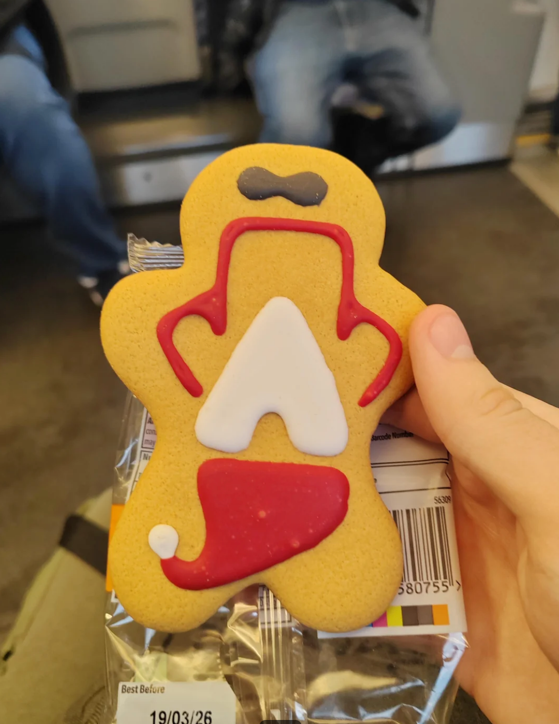 Gingerbread man cookie right-side up, revealing the Santa design is upside-down