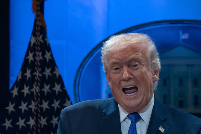 Person successful  a suit   speaking energetically connected  signifier    with a emblem  and emblem disposable   successful  the background