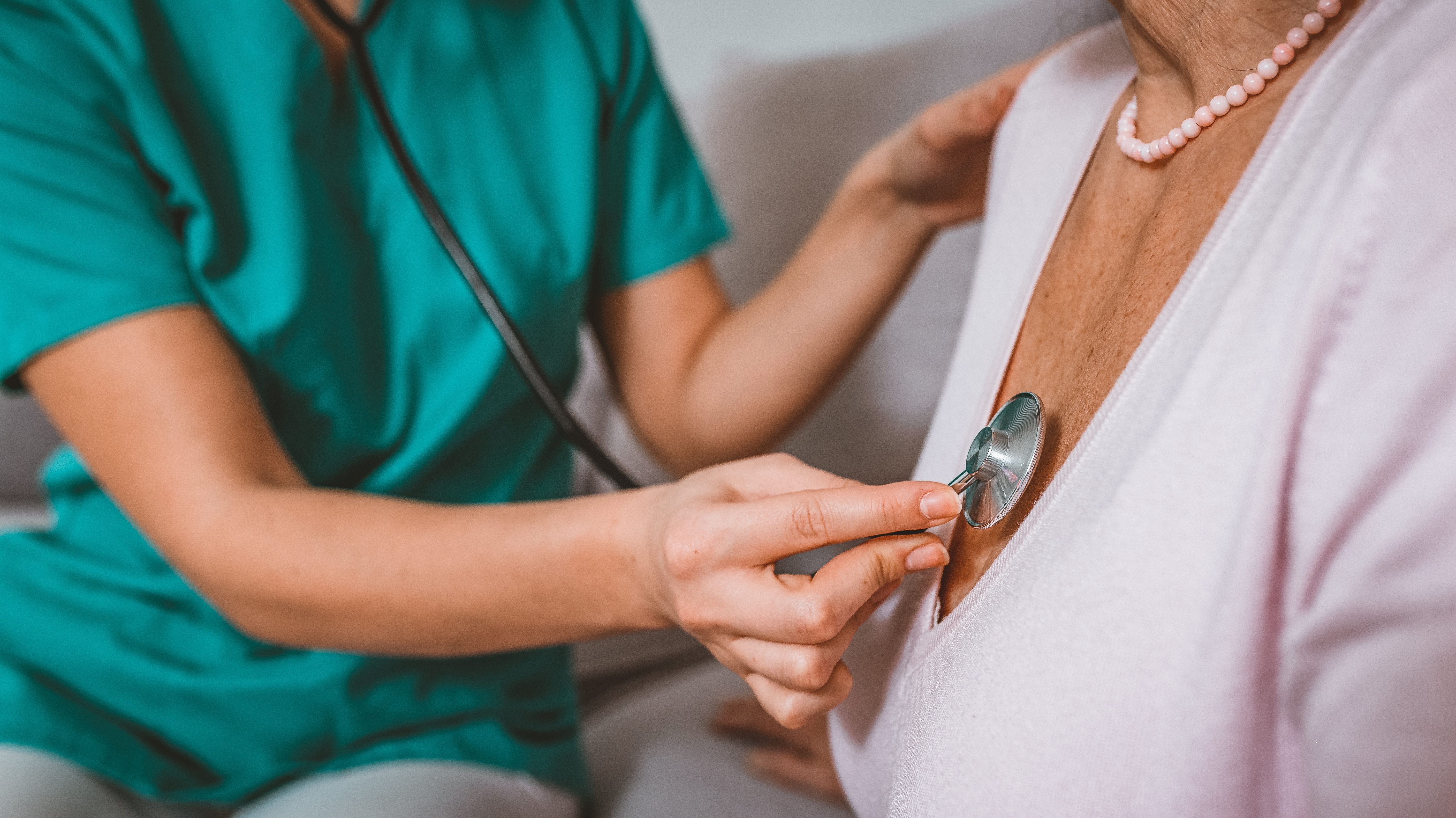 A healthcare nonrecreational checks a patient's heartbeat utilizing a stethoscope