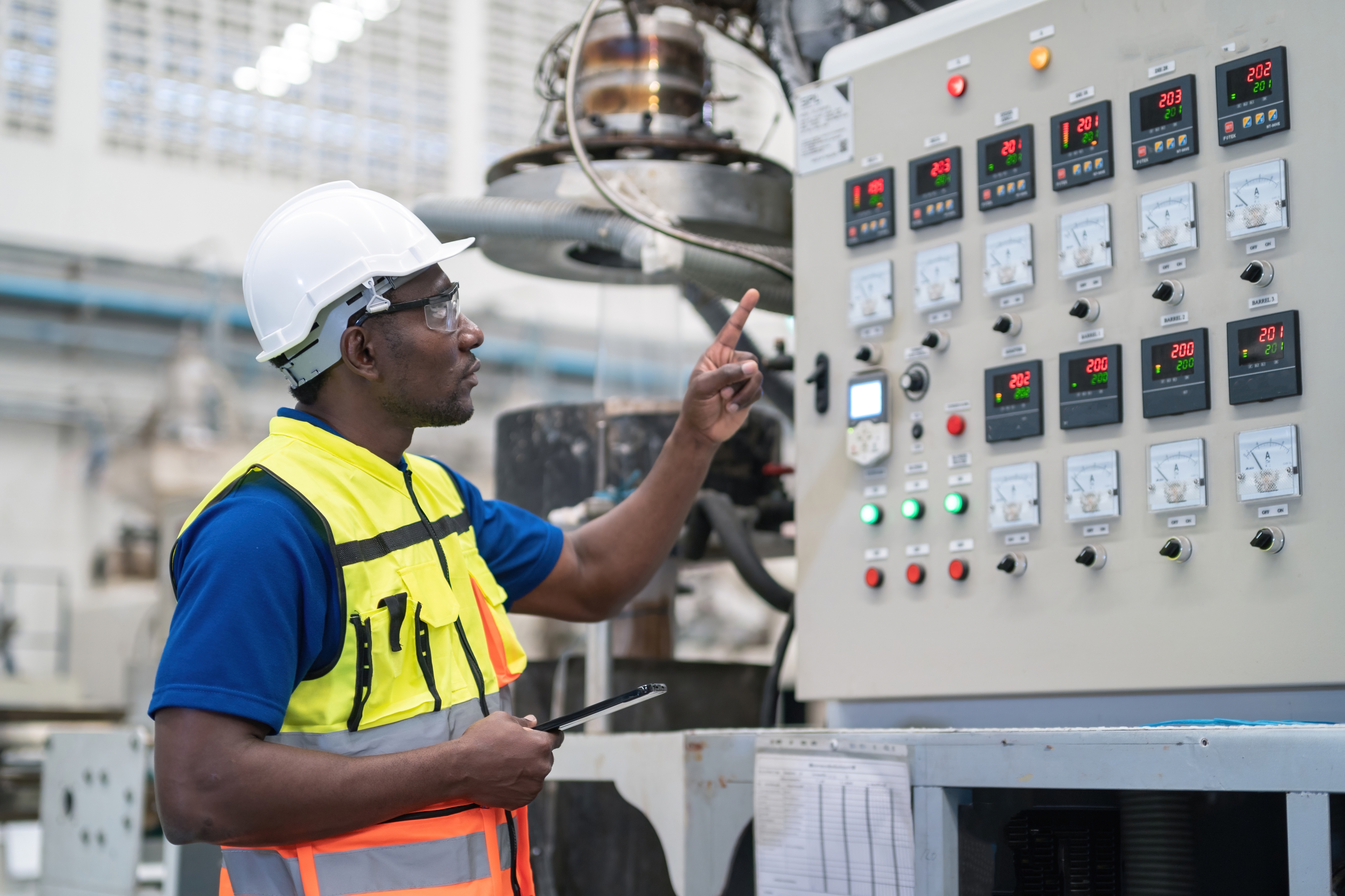 Engineer successful information cogwheel operates an concern power panel, monitoring machinery