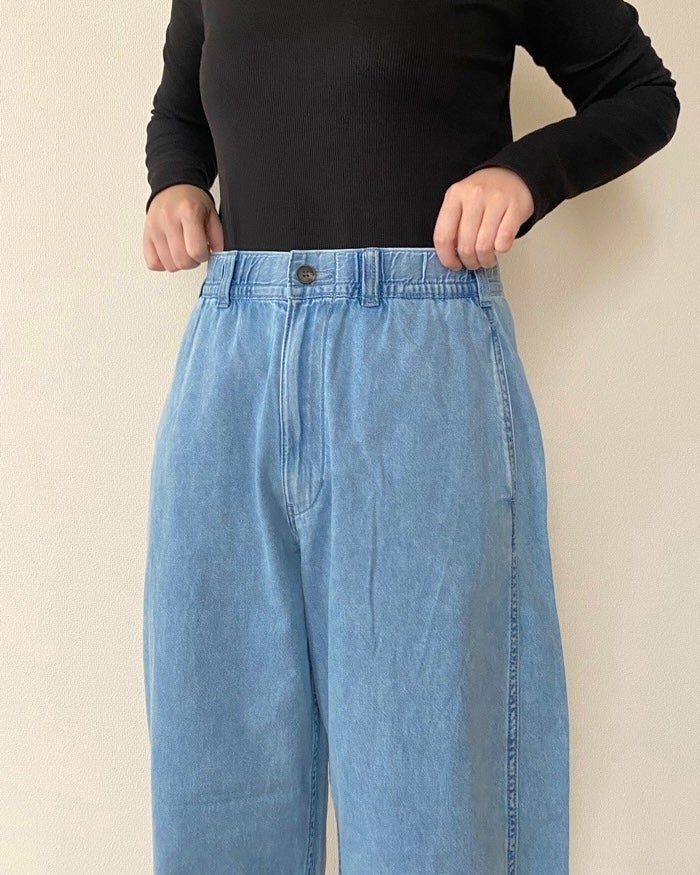 GUの「ライトデニムバレルレッグイージーパンツ（丈標準67.5～71.5cm）」黒いトップスにデニムパンツを穿く人が正面を向いています。