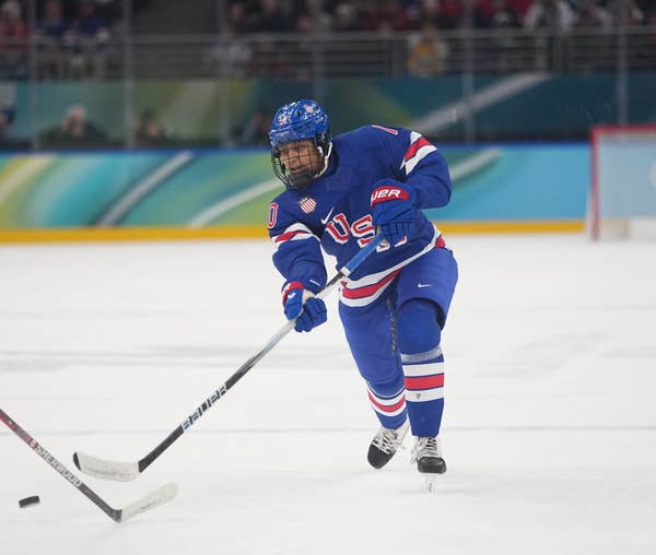 Hockey player Laila Edwards in USA gear skating on ice