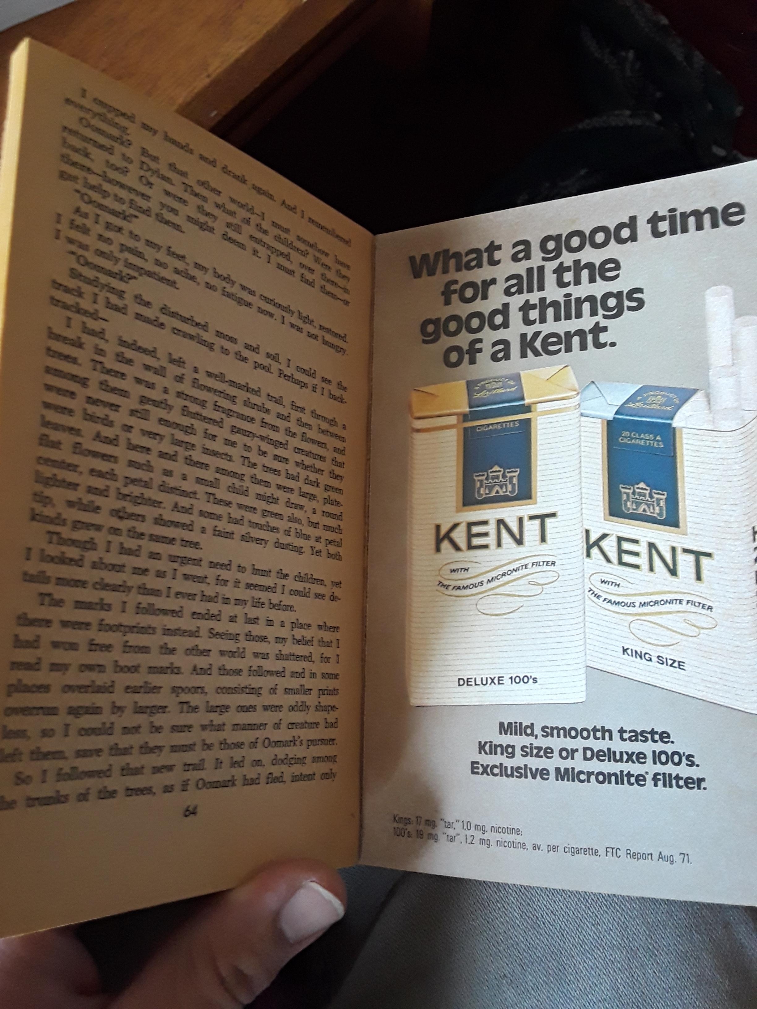Open publication  showing a Kent cigarettes advertisement, highlighting their creaseless  sensation  and exclusive Micronite filter. Partial substance   disposable   connected  the left
