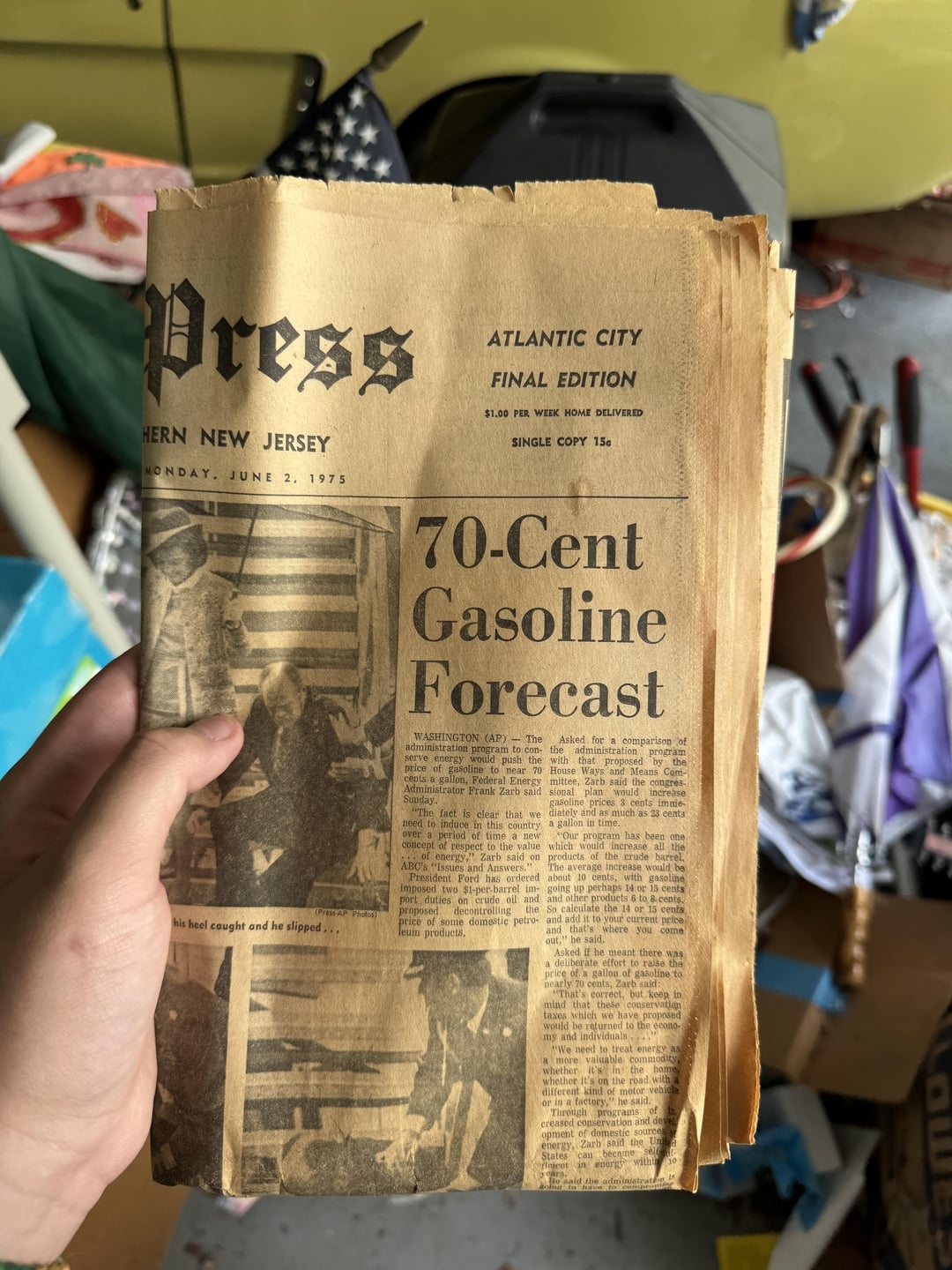 Person holding a vintage 1973 paper  with a header  predicting 70-cent gasoline prices