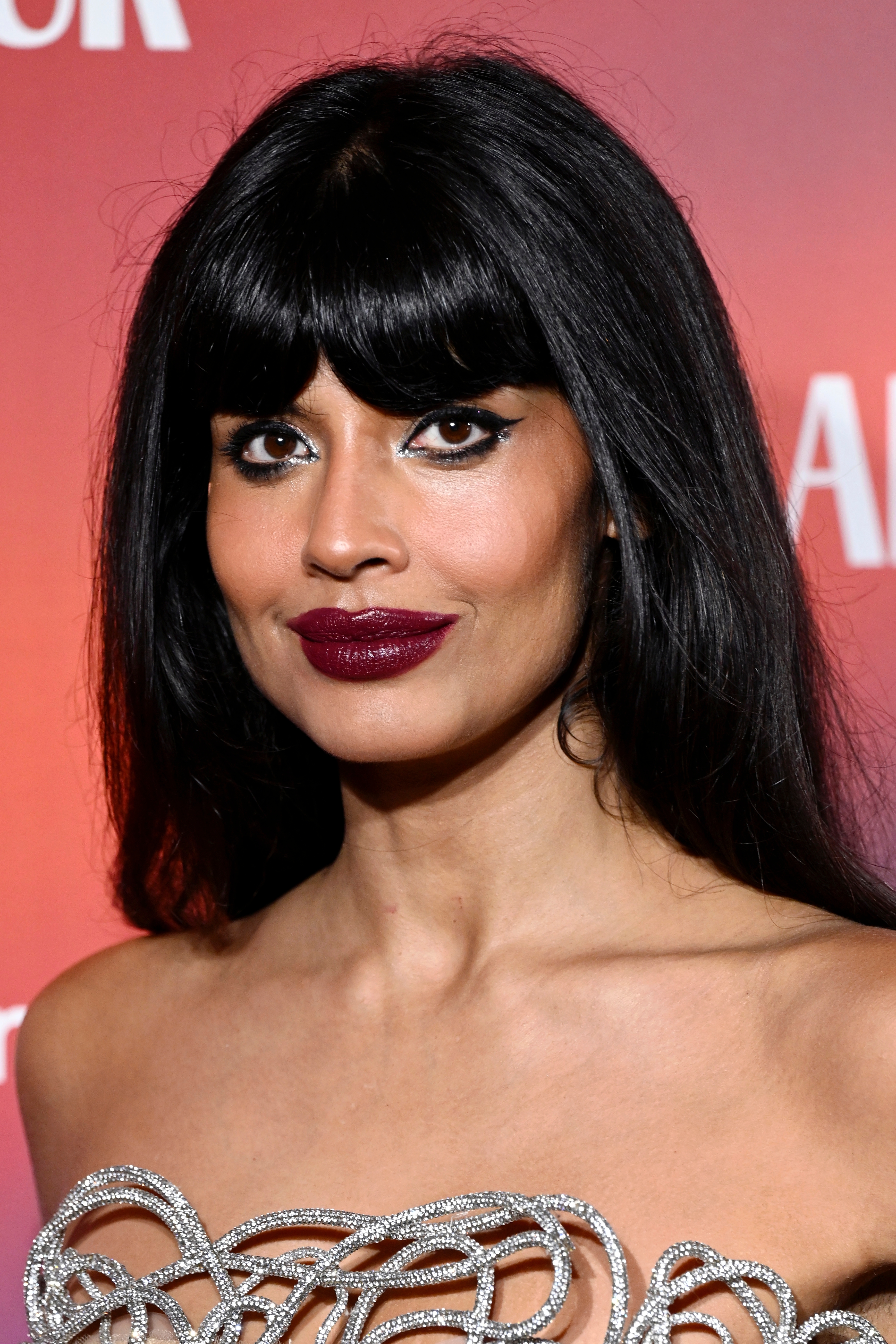 Jameela Jamil connected  a reddish  carpet successful  elegant attire with intricate metallic details and styled hair