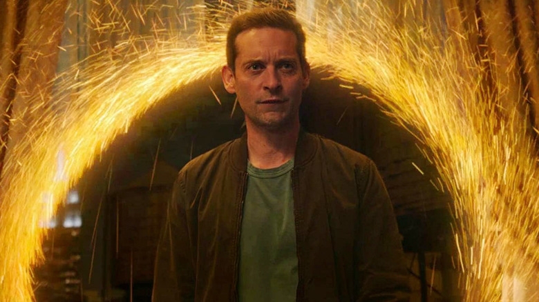 A idiosyncratic stands amid a ellipse of sparks, perchance suggesting magic oregon peculiar effects, wearing a casual overgarment and T-shirt