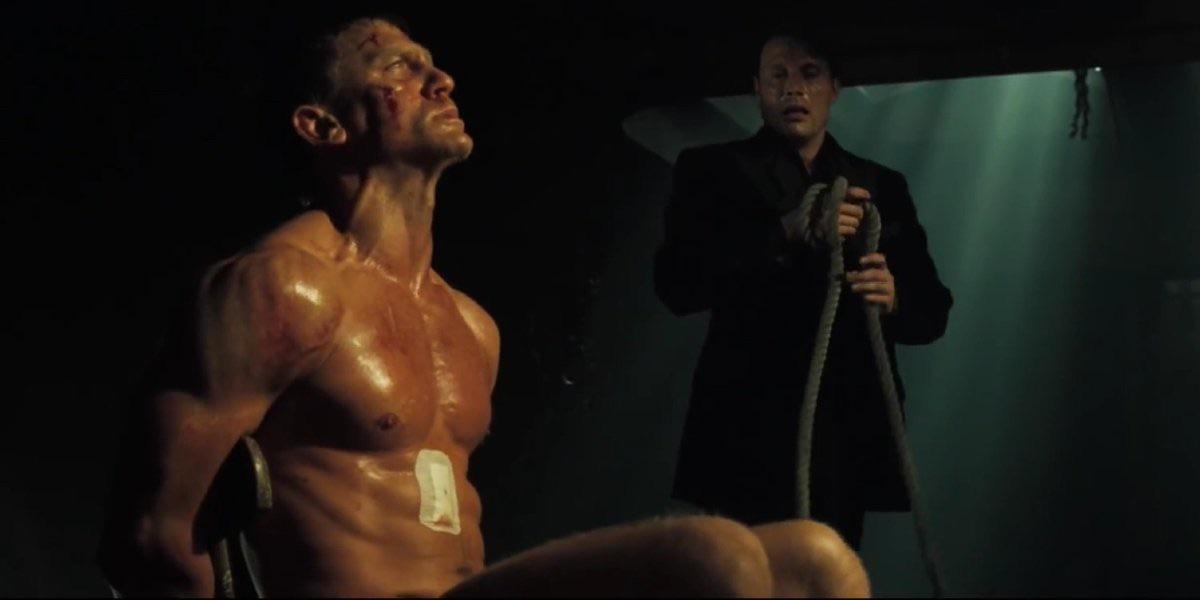 A country from a movie showing a antheral tied to a chair, facing an antagonist holding a rope, successful a dimly lit setting