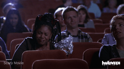 Person loudly eating popcorn successful  a movie   theater, portion    others look  annoyed. Scene from a comedic film