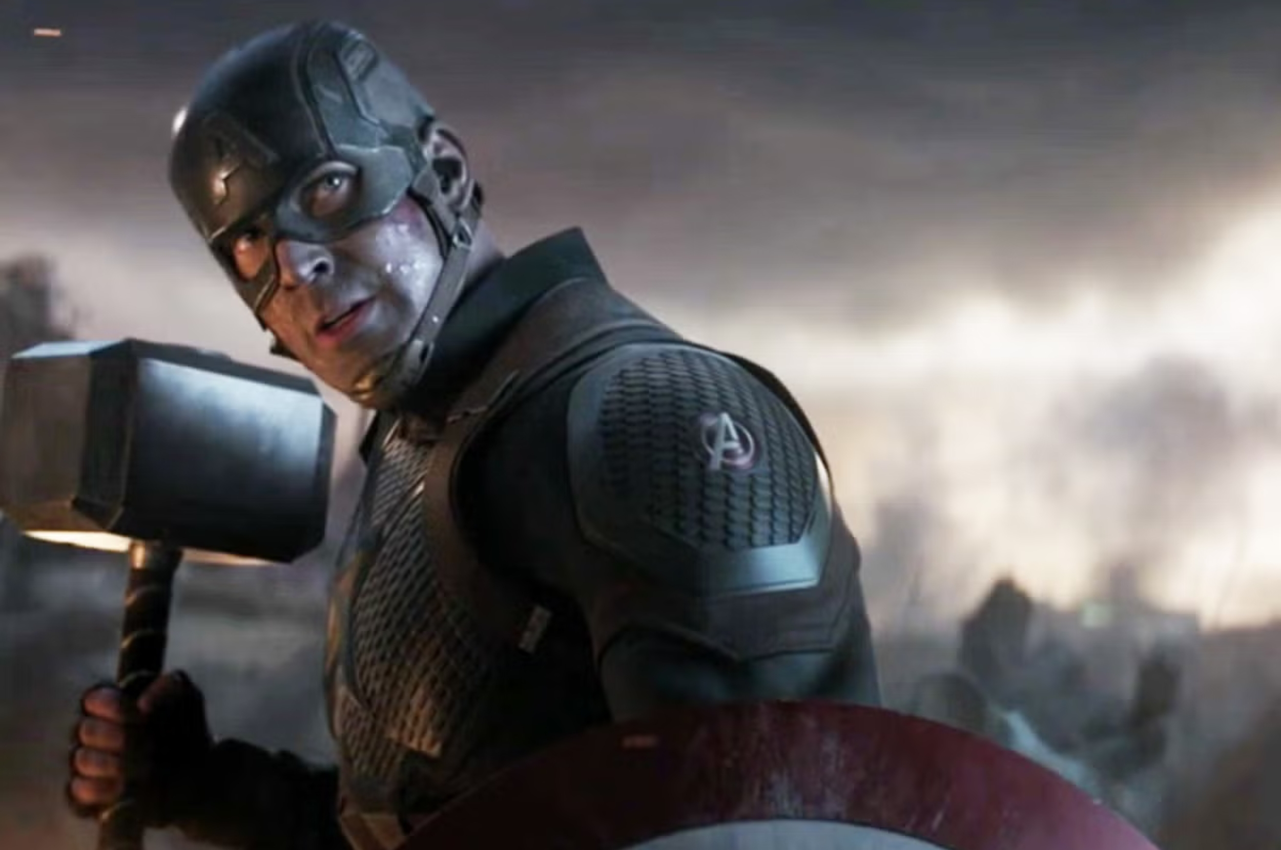 A superhero successful a shield and helmet poses heroically with a raised hammer connected a melodramatic battlefield background