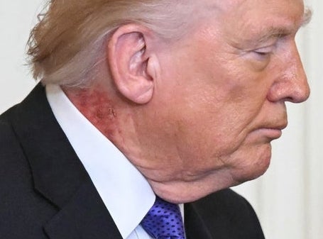 A person in a suit and tie is in profile