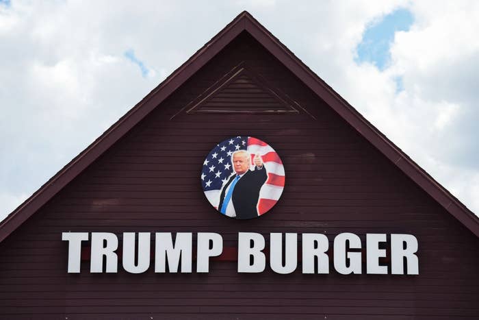 Sign on a building reads "Trump Burger" with an image of a man pointing in front of an American flag