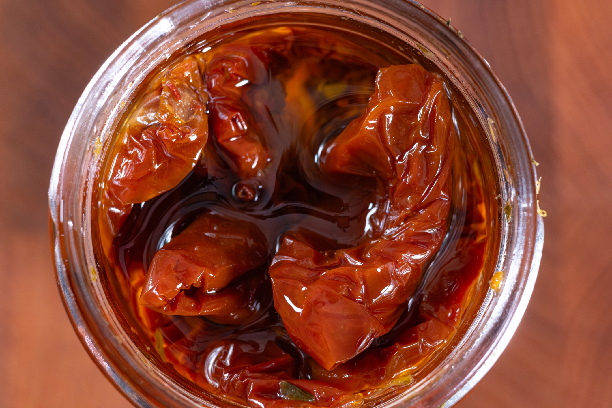 Jar filled with sun-dried tomatoes successful  oil, viewed from above