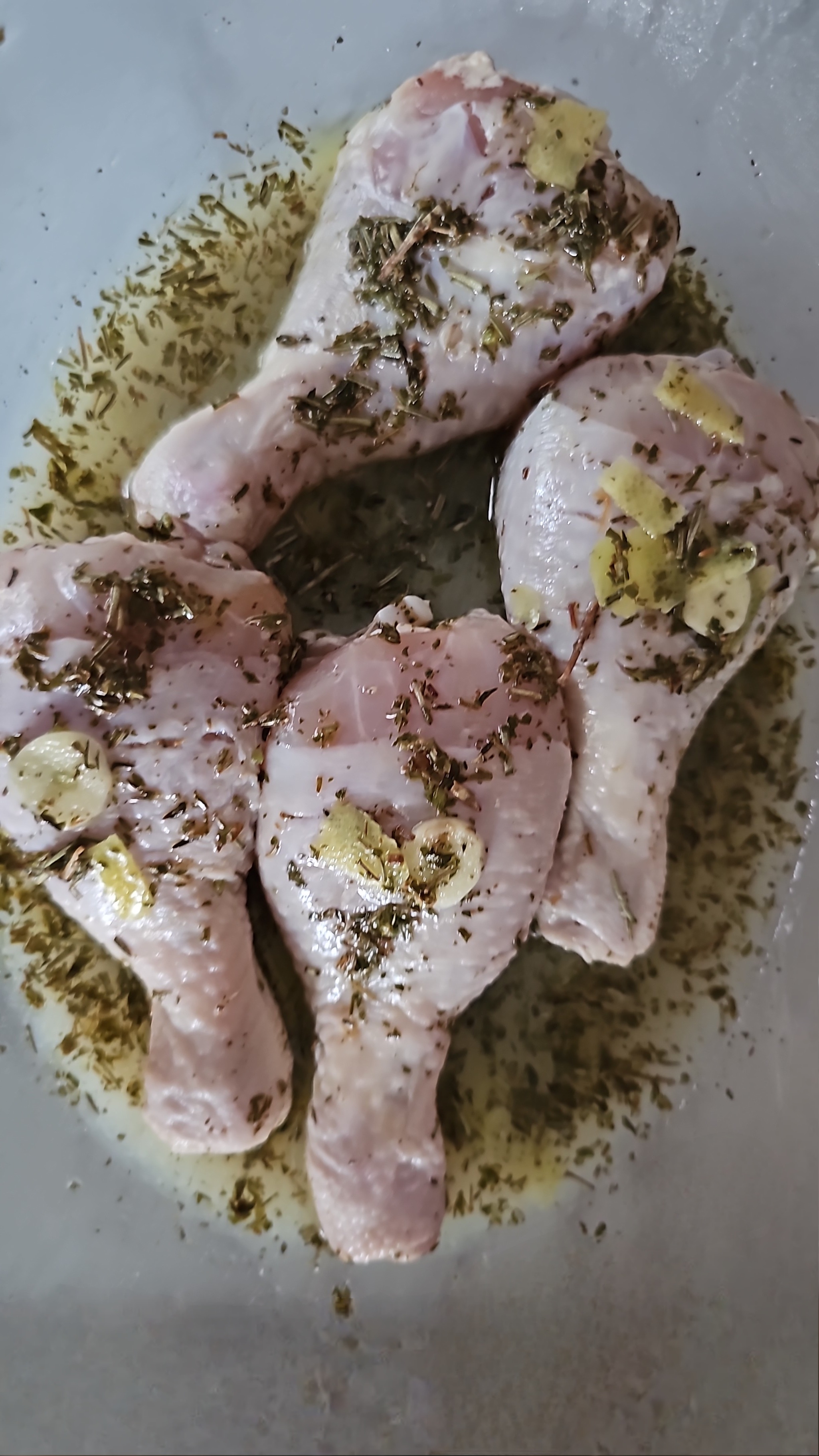 Four earthy   chickenhearted  drumsticks are marinated with herbs and ail  connected  a tray