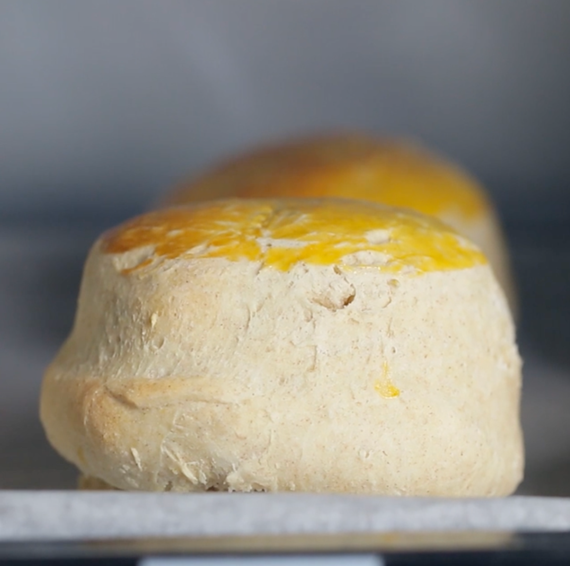 Two golden-brown breadstuff rolls cook successful an oven connected a sheet, showcasing a crusty exterior perfect for a delicious homemade breadstuff recipe