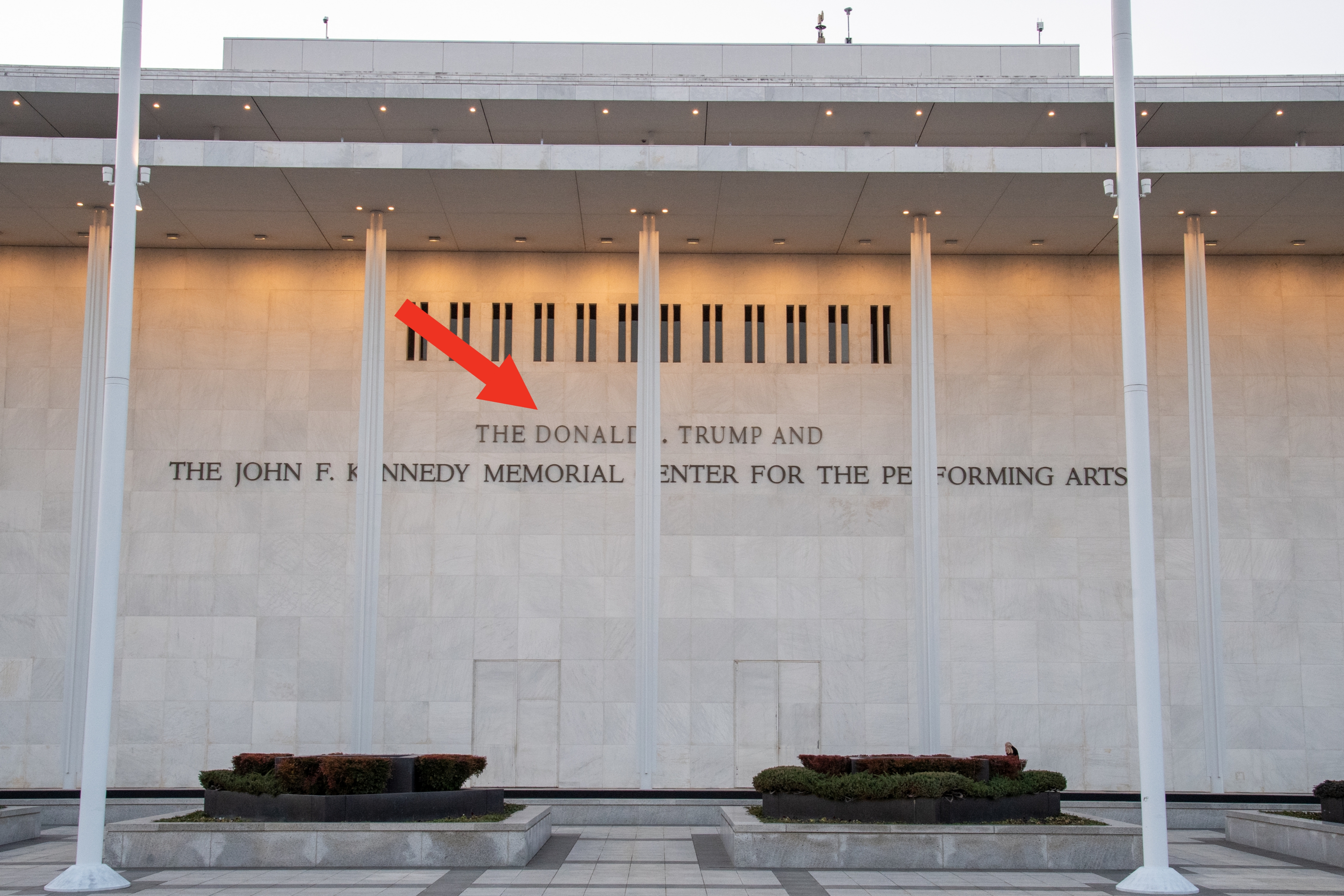 The exterior of the John F. Kennedy Center for the Performing Arts, featuring gangly pillars and "The Donald J. Trump and The John F. Kennedy Memorial" text