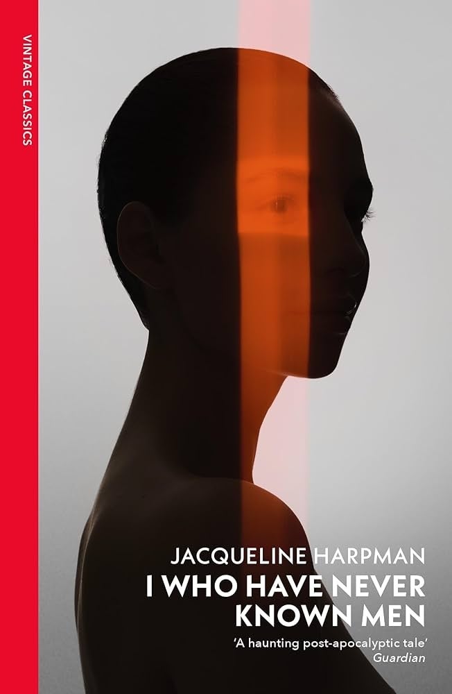 Book cover: "I Who Have Never Known Men" by Jacqueline Harpman. Silhouette of a woman's profile with a vertical orange light beam