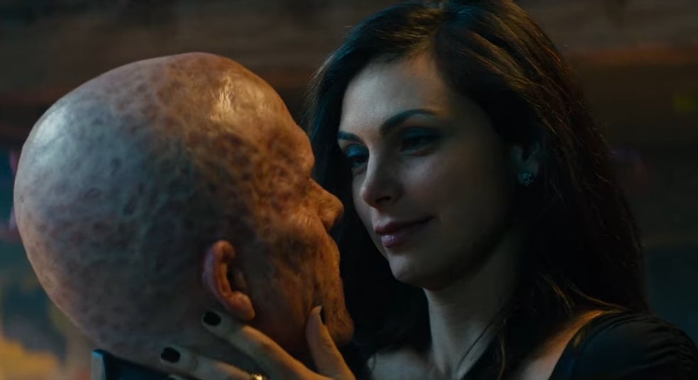 Vanessa intimately holding Deadpool's face