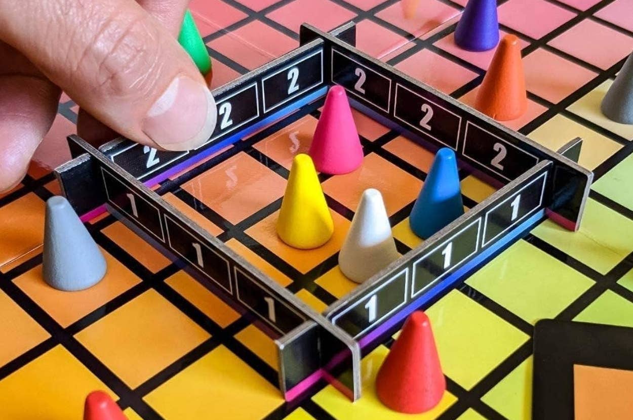 closeup of hand playing Hues and Cues