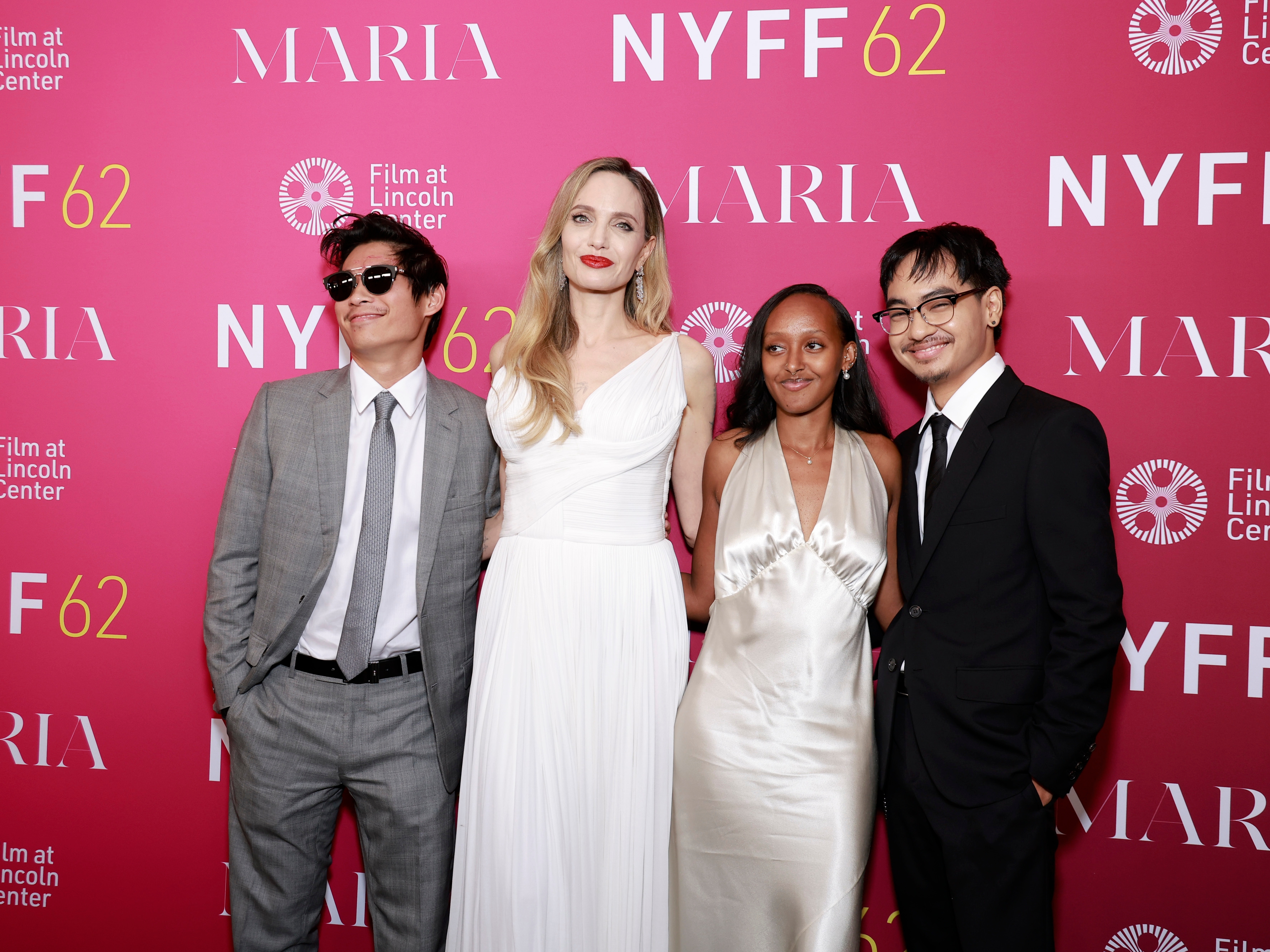 Four radical successful ceremonial attire airs for a photograph astatine a reddish carpet lawsuit with "NYFF62" and "Maria" signage successful the background