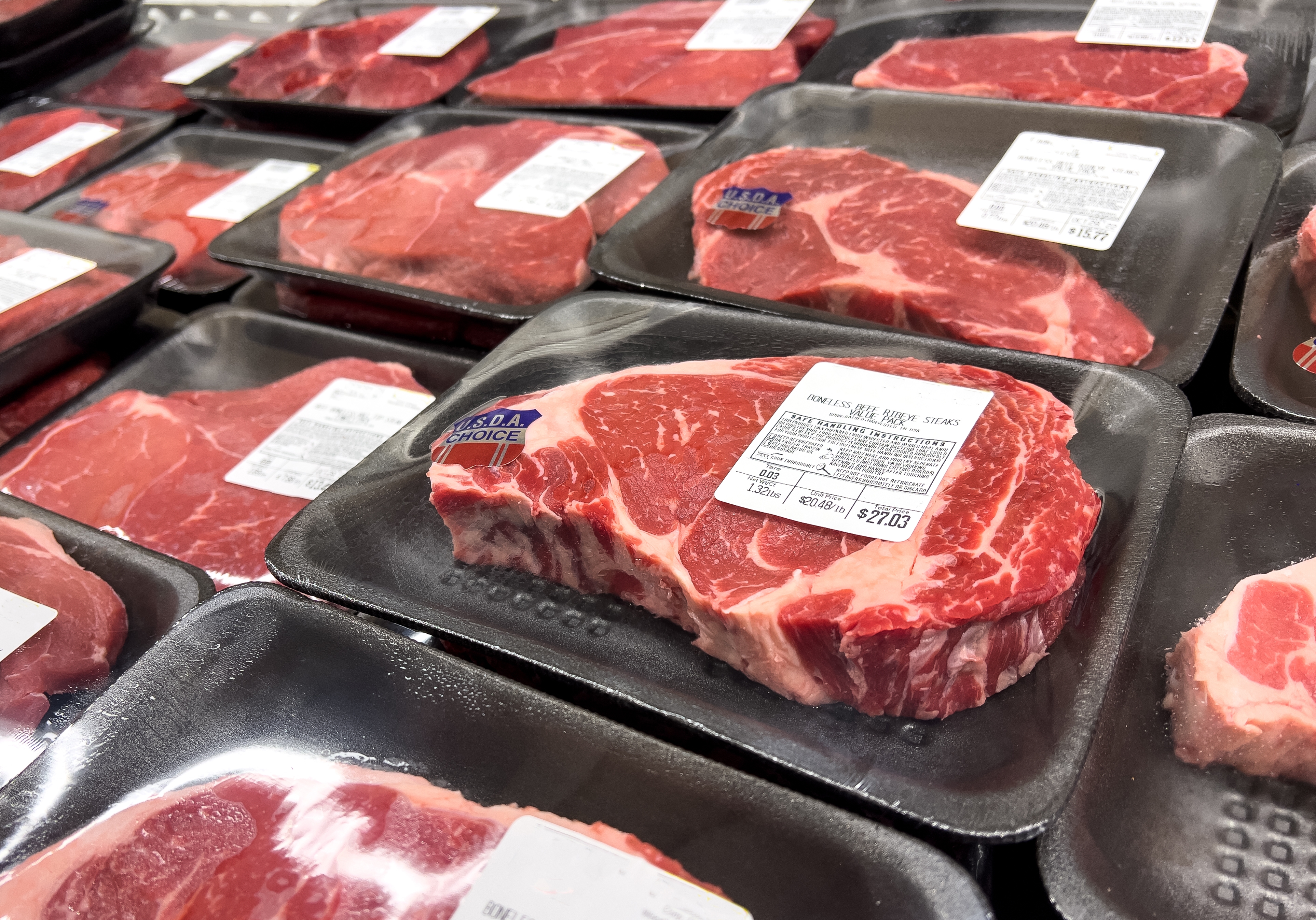 Packages of earthy   steak connected  show  successful  a market  store, highlighting prime   grading labels and pricing