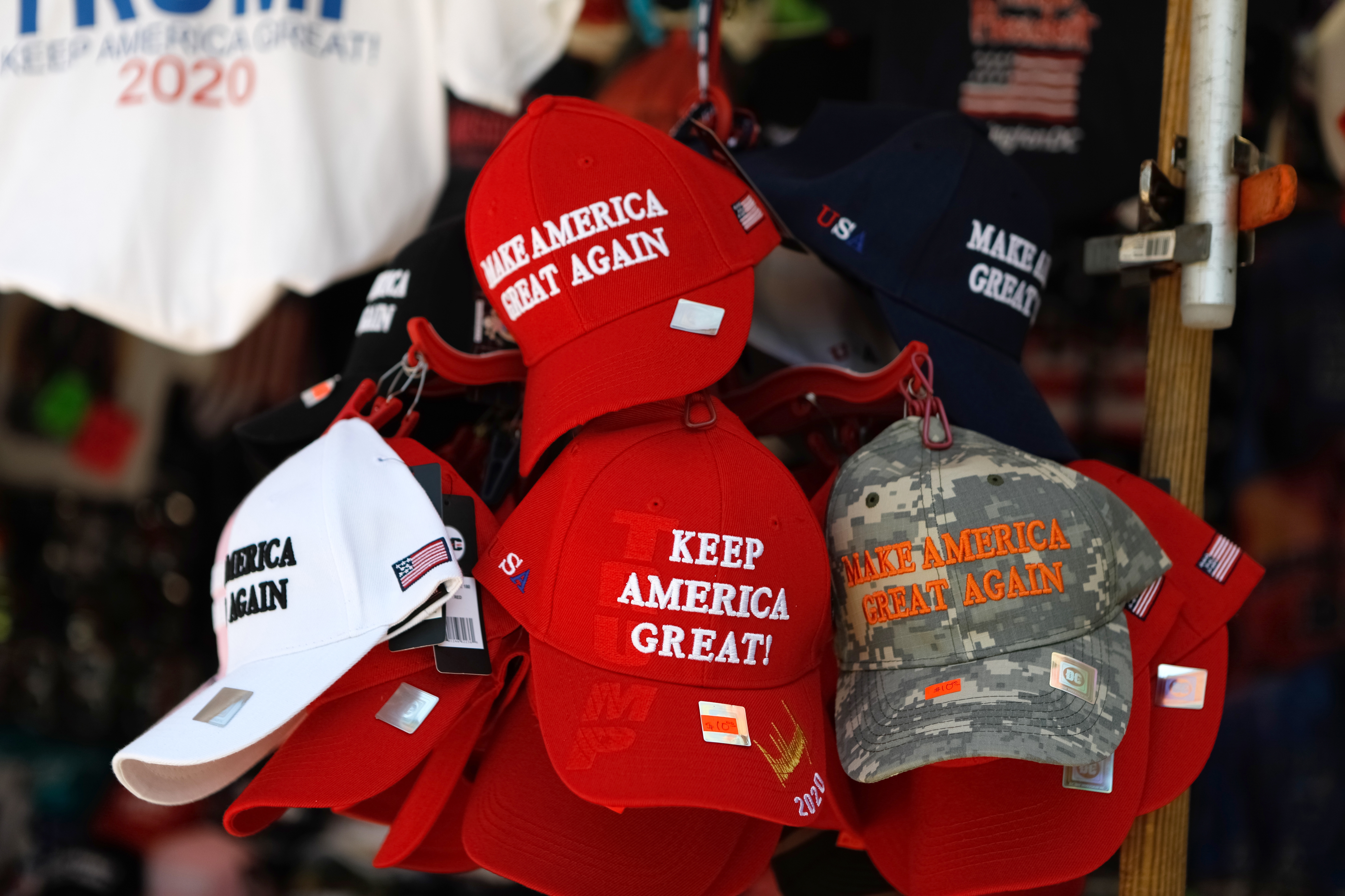 Hats with "Make America Great Again" and "Keep America Great" slogans are displayed connected  a rack