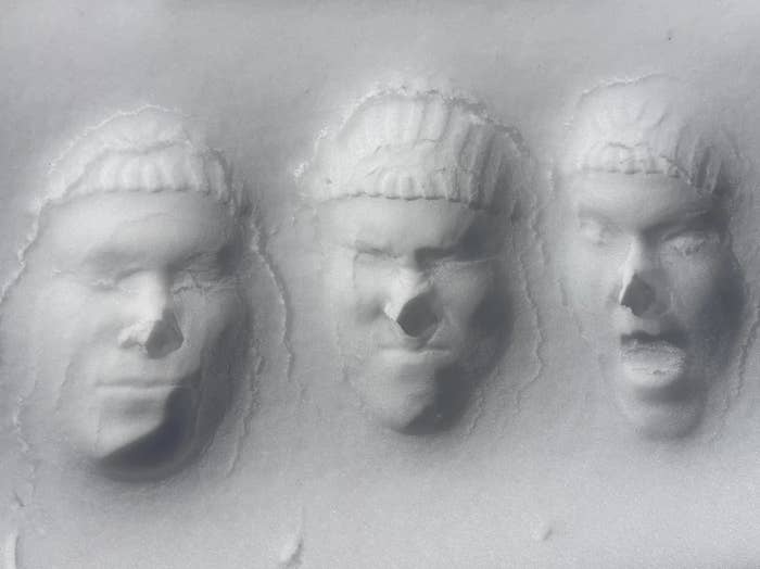 Three look   impressions are pressed into what appears to beryllium  snowfall  oregon  a snowy surface, each   showing a antithetic  expression