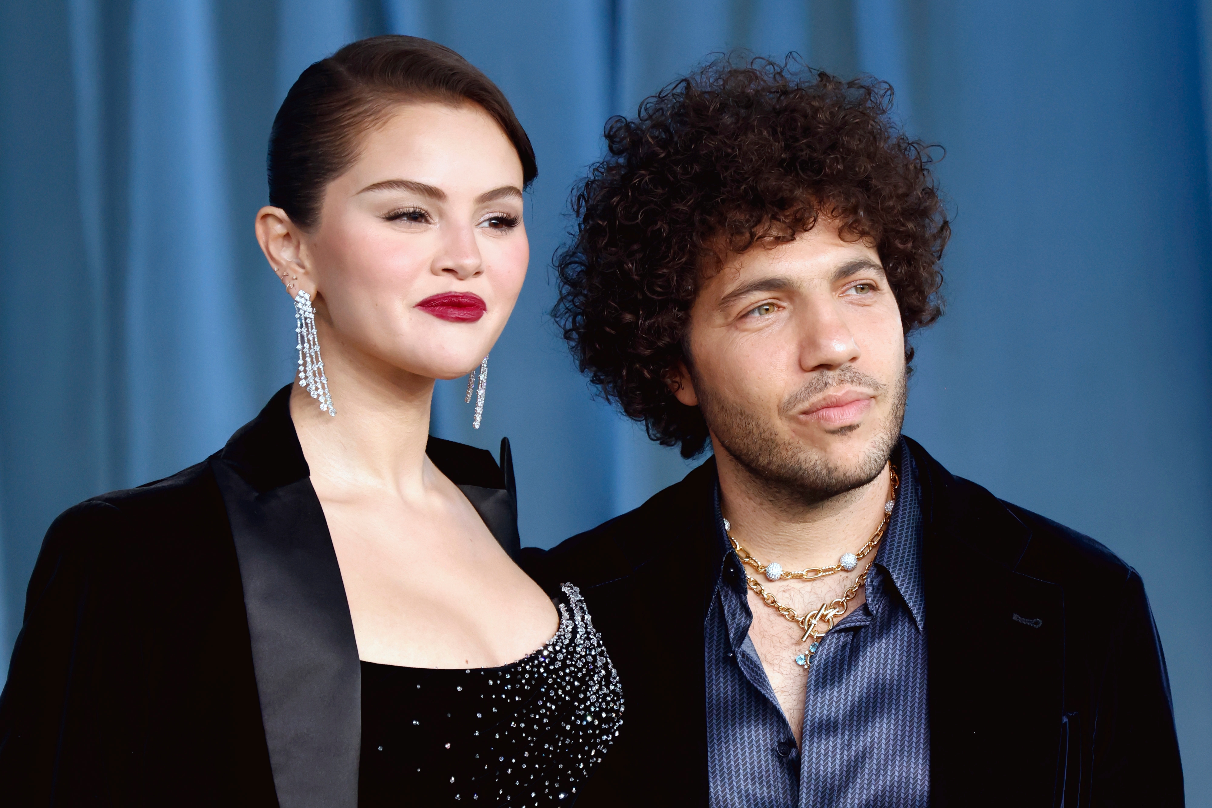 Two individuals basal   together; the idiosyncratic   connected  the near  wears a bejeweled gown and striking earrings, portion    the idiosyncratic   connected  the close    wears layered necklaces