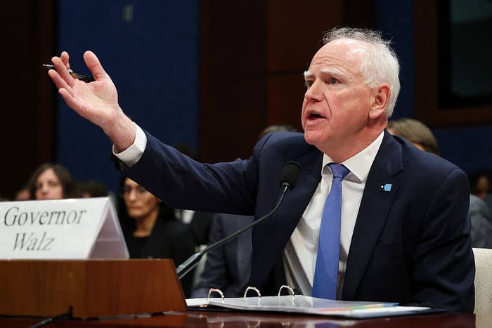 Person astatine  a hearing, gesturing portion    speaking. Nameplate reads "Governor Walz." Seated astatine  a array  with a microphone successful  front