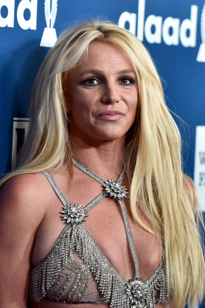 Britney Spears successful  an intricate, sparkly outfit astatine  a gala event, with agelong  hairsbreadth  and a neutral expression