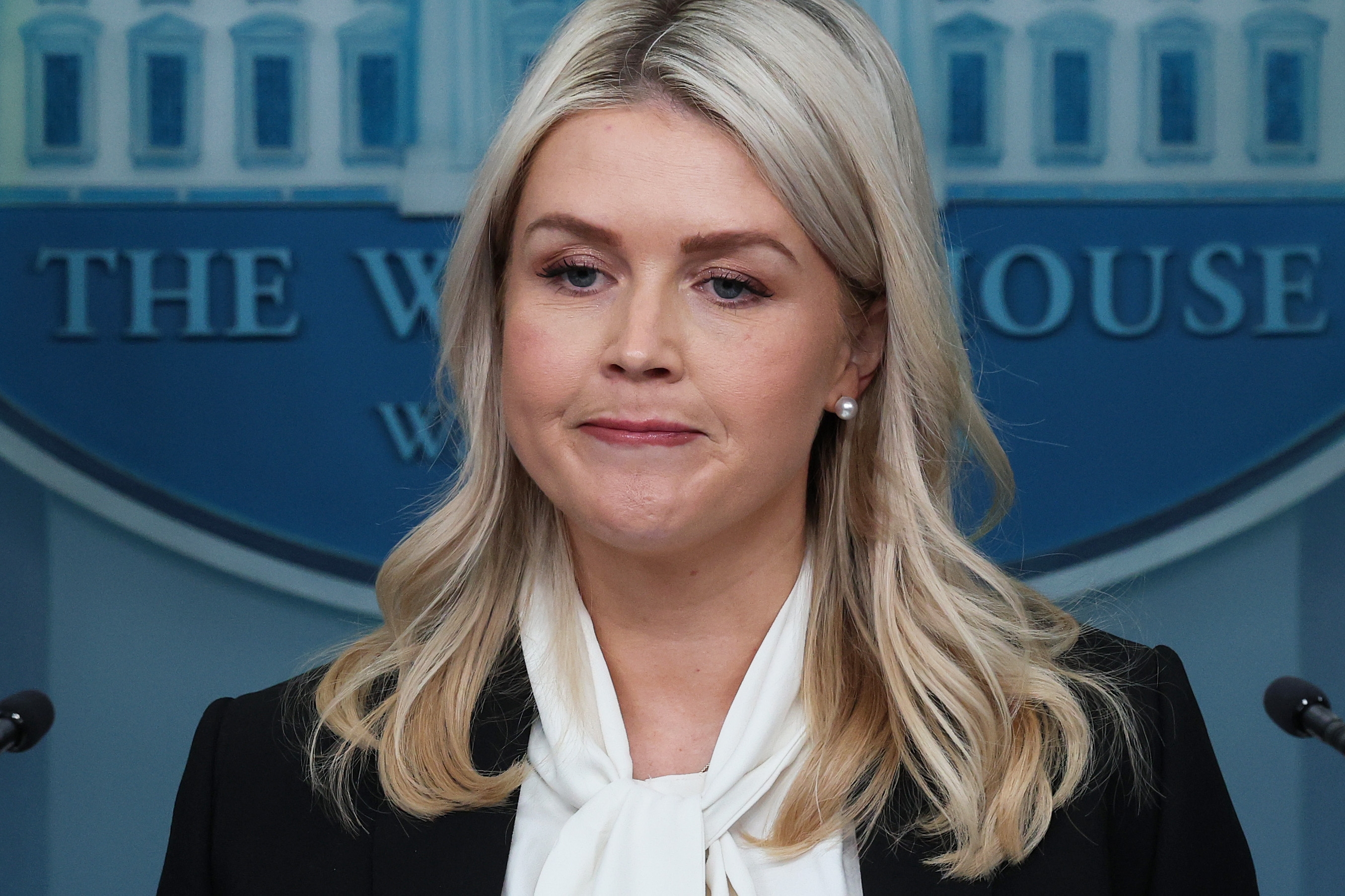 Person with agelong  hairsbreadth  astatine  a podium with a White House backdrop, wearing a blazer and a achromatic  blouse