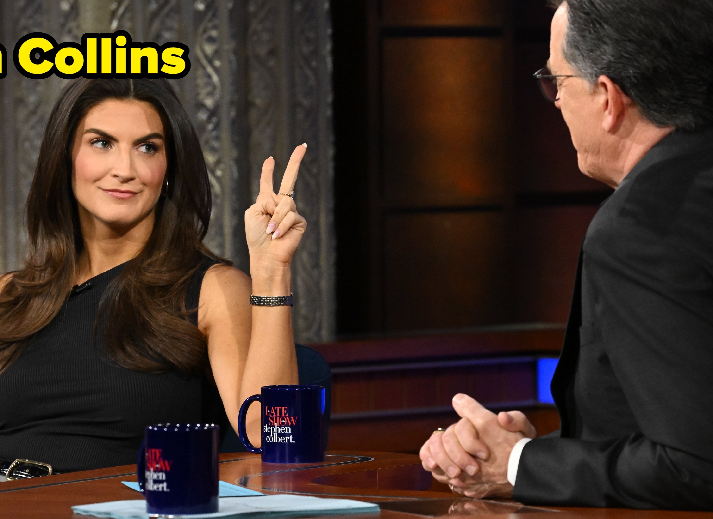 A pistillate   gestures with a bid    motion   during a speech   amusement   interview, seated with a big   successful  a workplace  setting