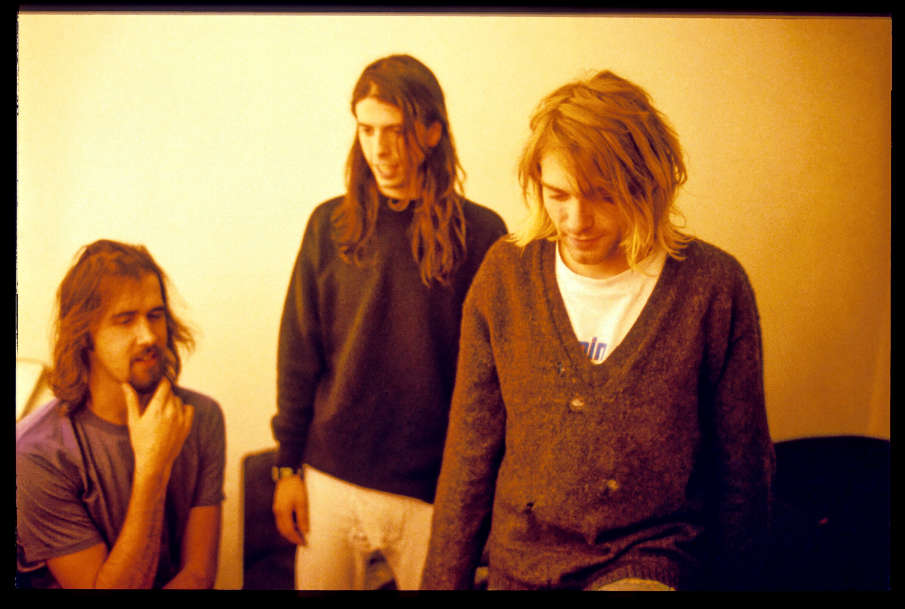 Three men successful  casual 90s attire, with agelong  hair, basal   unneurotic  successful  a relaxed setting, 1  successful  thought, different  smiling gently