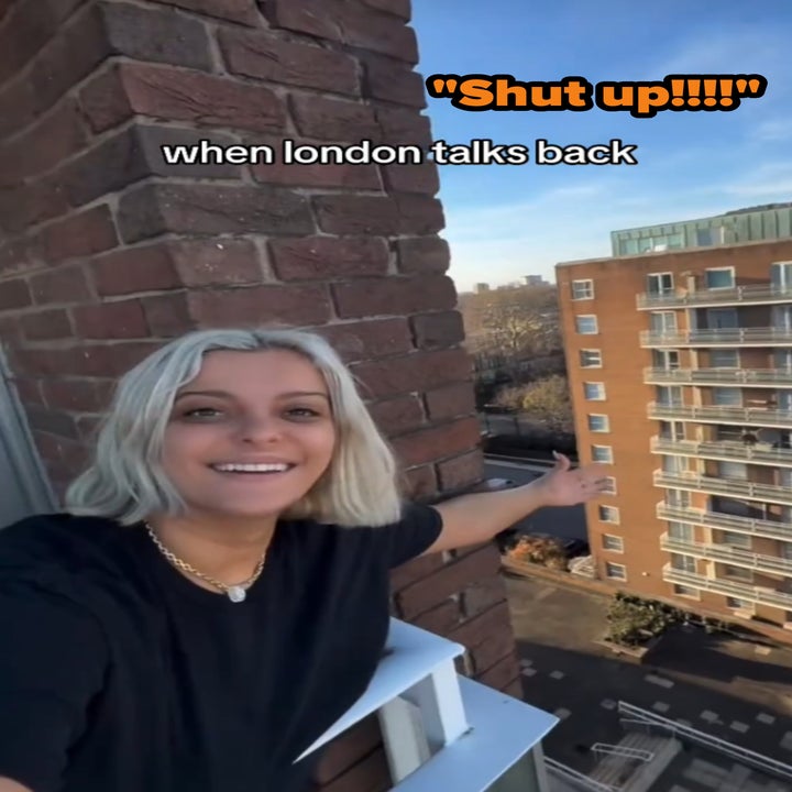 Person with short blonde hair smiles and gestures towards buildings from a balcony with the text "when london talks back" above
