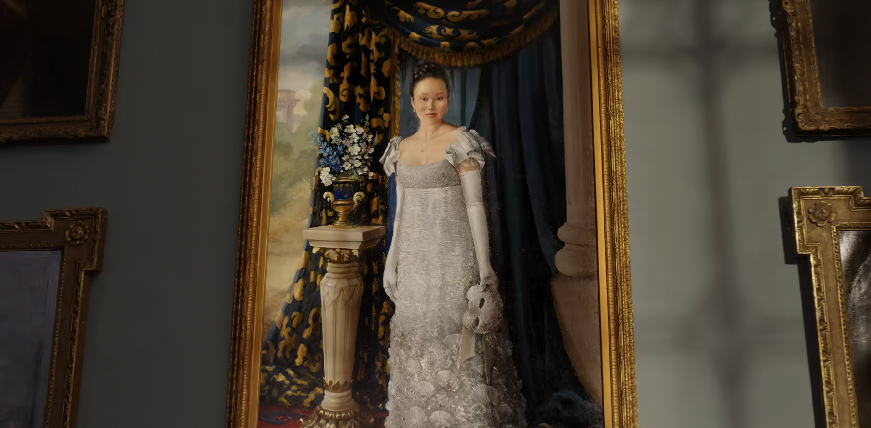 A portrait of a woman in elaborate, vintage-style attire holding a small dog, set against a classic backdrop with curtains and a vase