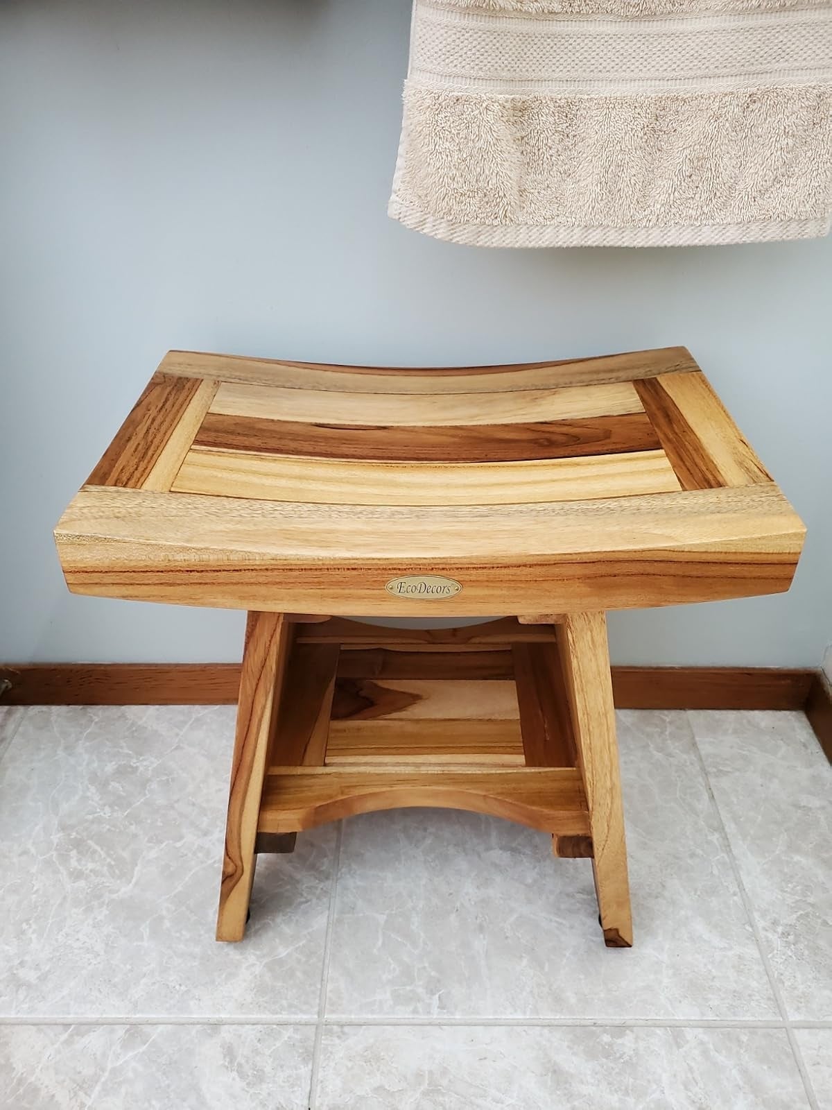 Wooden bath stool with a slatted seat, showcasing a natural finish and sturdy build, suitable for bathroom use
